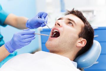 dentist checking tooth of patient in tarzana